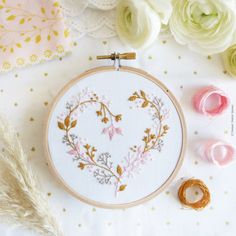 a close up of a embroidery on a table with flowers