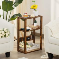 a living room with white furniture and flowers on the table