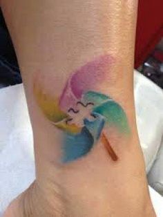 a colorful tattoo on the foot of a woman