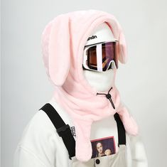 a person wearing ski goggles and a pink bunny outfit