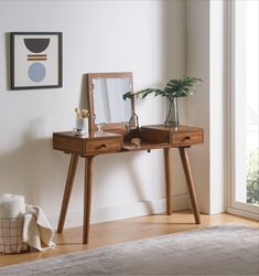 a wooden desk with a mirror and plant on it