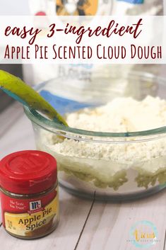 an apple pie is in a glass bowl next to a jar of dough and a pickle