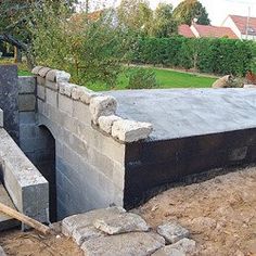 an unfinished concrete structure is being built in the yard