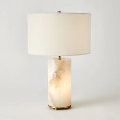 a table lamp with a white shade on it