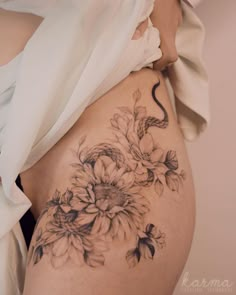 a woman's stomach with flowers on it and the bottom part of her belly