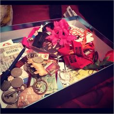 an open box filled with assorted items on top of a table