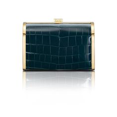 A new silhouette from STALVEY's signature collection, the Rounded Clutch is an evening clutch with alligator or lizard skin, perfectly placed within a palladium or 24kt gold hardware frame. A rounded curvature at the top front of the clutch provides an elegant feel. Square push pin opens the clutch up to a spacious leather-lined interior. Two custom STALVEY twist screws on either side of the chain provides an adjustable shoulder strap drop height, perfect for transitioning from daytime wear to e Lizard Skin, Custom Top, Nature Ring, Metal Accents, 24kt Gold, Evening Clutch, Signature Collection, Push Pin, Metallic Accents