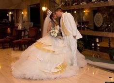 a bride and groom kissing in a hotel lobby