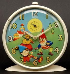 a clock with an image of two gnomes on it's face and numbers