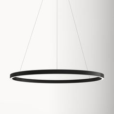 a black circular light fixture hanging from a ceiling lamp with two lights on each side