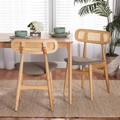 a wooden table with two chairs next to a plant and potted plant on top of it