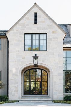 the front entrance to a large white brick house