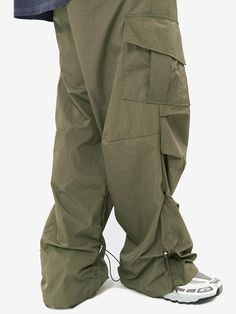 Editor's notesRipstop String Cargo Pants by NON FLOOR features strings placed on both sides of the side line, and the silhouette and shirring detail of the pants are determined by the degree of tightening the strings. This pants can be styled with a silhouette ranging from wide to flared, allowing for versatile styling options. The interior is treated with mesh, preventing it from sticking to the skin even when worn as nylon pants in sweaty conditions.- Cargo pocket on both sides of the side lin Outdoor Techwear Parachute Pants With Drawstring, Khaki Utility Parachute Pants With Drawstring, Green Drawstring Bottoms For Outdoor Activities, Utility Khaki Bottoms With Functional Drawstring, Techwear Parachute Pants With Drawstring, Techwear Bottoms With Drawstring For Outdoor, Outdoor Techwear Bottoms With Drawstring, Sporty Khaki Pants With Drawstring, Khaki Drawstring Pants For Outdoor Activities