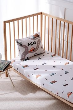 a baby crib with a pillow on top of it