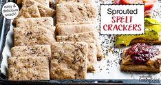 a tray with crackers, tomatoes and other food on it next to a sign that says sprouted seed crackers