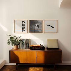 a record player sitting on top of a wooden cabinet