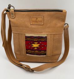 "TAOS COLLECTION Midsize Red Multicolored Southwest Hand Weaving on Brown Leather Tote Shoulder Bag Crossbody Purse + outside pocket & zipper -- Jackson Place Collection Large:   12\" x 11\" x 4\" Color:  Taos Red Multicolored on tan brown leather Hand loomed weaving Brown stoned oil leather cowhide Genuine Leather Zipper Closure 1 Inside Pocket Leather Tassel Adjustable Shoulder or Crossbody Bag Strap" Crossbody Bag Strap, Bag Pocket, Brown Leather Totes, Brown Leather Bag, Taos, Leather Tassel, Leather Zipper, Crossbody Purse, Bag Straps