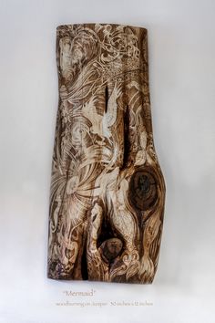 a sculpture made out of wood with designs on it