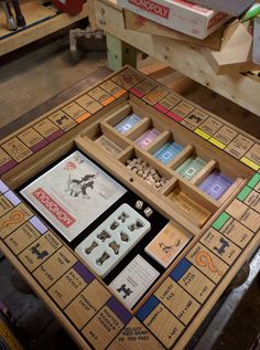 a wooden table topped with lots of game pieces