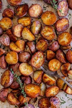 roasted potatoes with herbs on a baking sheet