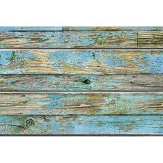 an old wooden wall with peeling paint and chipped paint on the wood planks