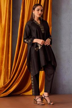 Black asymmetric tunic featuring sequin flower patch embroidery and a V neck. Paired with side stripe pants for a coordinated look., Fit: Relaxed Side Stripe Pants, Asymmetric Tunic, Neck Flower, Sequin Flower, Stripe Pants, Patch Embroidery, Flower Patch, Embroidered Tunic, Pant Sets