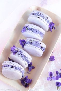 purple and white macaroons on a plate with flowers