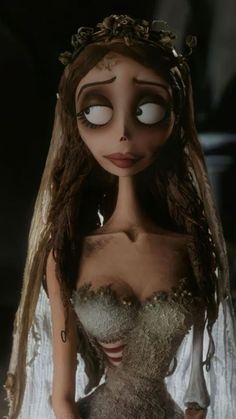 the corpse bride doll is dressed in white and has long hair with eyes wide open