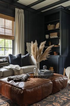 a living room filled with furniture and lots of pillows on top of a rug in front of a window