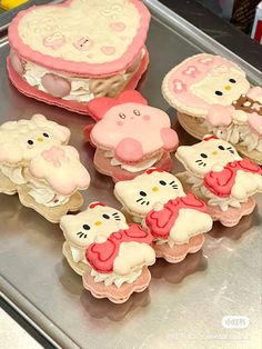 hello kitty cupcakes are sitting on a tray