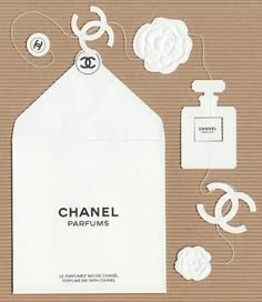 the chanel logo is surrounded by paper flowers and other items that are on display