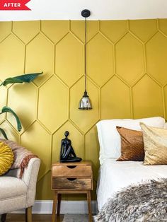 a bed room with a neatly made bed next to a chair and a wall mounted plant