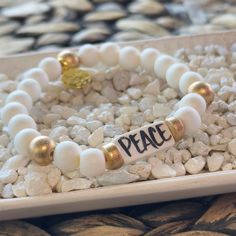 Affirmation bracelets featuring a hand-lettered affirmation focal bead and our abstract print beads and gold logo charm. Stretchy to fit most wrists. Inspirational White Bracelet With 8mm Beads, Inspirational White Name Bracelet With Round Beads, Inspirational White Bracelets For Friendship, Inspirational White Name Bracelet With Letter Beads, Inspirational Adjustable White Name Bracelet, Spiritual White Stretch Bracelet With Letter Beads, White Spiritual Stretch Bracelet With Letter Beads, White Inspirational Stretch Bracelet With 8mm Beads, Inspirational White Adjustable Name Bracelet