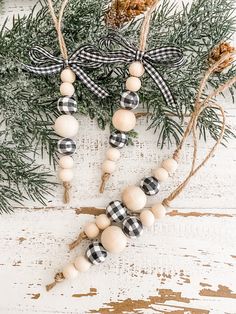 a wooden bead necklace with black and white buffalo plaid beads hanging from it's side