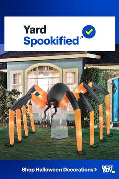 yard spookfied halloween decorations are in front of a house with an orange spider on it