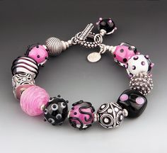 Beaded Bracelet - Ideas come from odd places; this color way was prompted by a whimsical fabric featuring tiny pandas on a bright pink background.  Handmade glass beads are accented with sterling silver beads, fine silver spacers and a signature tag. The beads are strung using a 49 strand braided and coated metal wire for strength. The toggle clasp is embellished with a dangle bead, which adds balance when worn, and allows easy clasping. Some variation in shading and bead sequence will occur, bu Perler Bead Bracelet, 2023 Necklace, Panda Bracelet, Bracelets Pretty, Lampwork Bracelets, Lampwork Bead Jewelry, Doll Things, Beaded Jewelry Bracelets, Seahawks Football