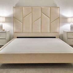 a white bed with beige headboard and night stands