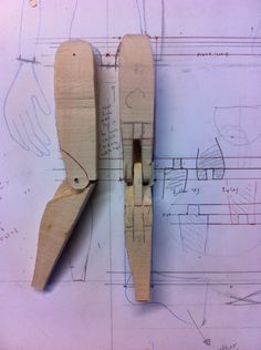 two pieces of wood sitting on top of a blueprint