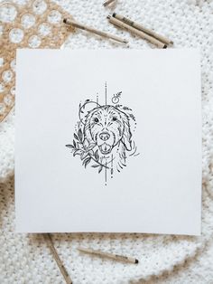 a drawing of a dog's face on top of a piece of white paper