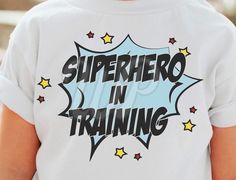 the back of a person's shirt that says superhero in training with stars on it