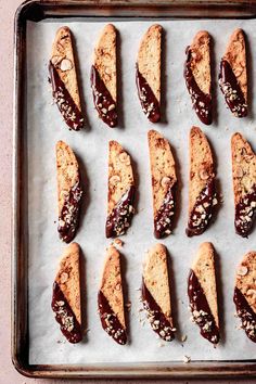 several pieces of food are lined up on a baking sheet and ready to be baked