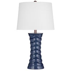 a blue ceramic lamp with a white shade