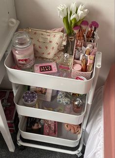 a white shelf filled with lots of makeup and other items