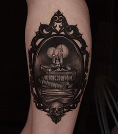 a black and white photo of a person's leg with a tattoo on it