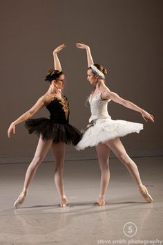 two ballerinas in tutu and leotards posing for the camera