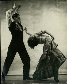 an old photo of two people dancing