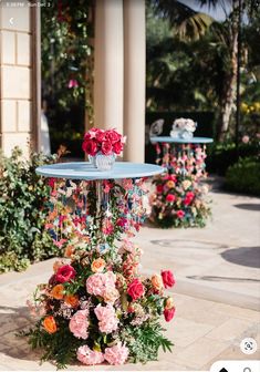 an outdoor fountain with flowers on it