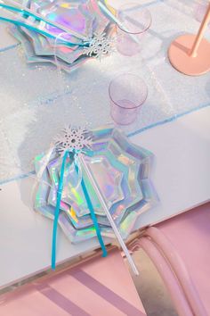 the table is covered with holographic paper and plastic umbrellas