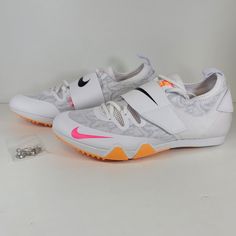 a pair of white shoes with pink and orange accents on the soles are shown