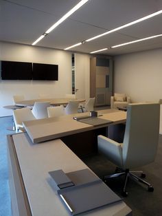 an empty office with desks and chairs